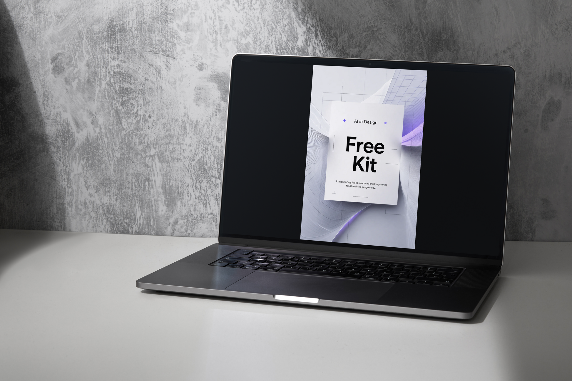 Laptop on a gray surface with a concrete wall background